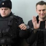 Russian opposition leader Alexei Navalny sits handcuffed