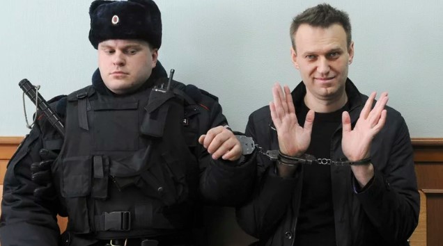 Russian opposition leader Alexei Navalny sits handcuffed