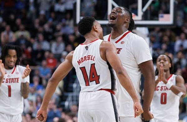 N.C. State’s Casey Morsell and DJ Burns Jr. celebrate in the closing seconds of the Wolfpack’s