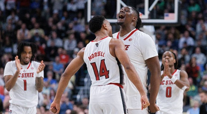 N.C. State’s Casey Morsell and DJ Burns Jr. celebrate in the closing seconds of the Wolfpack’s