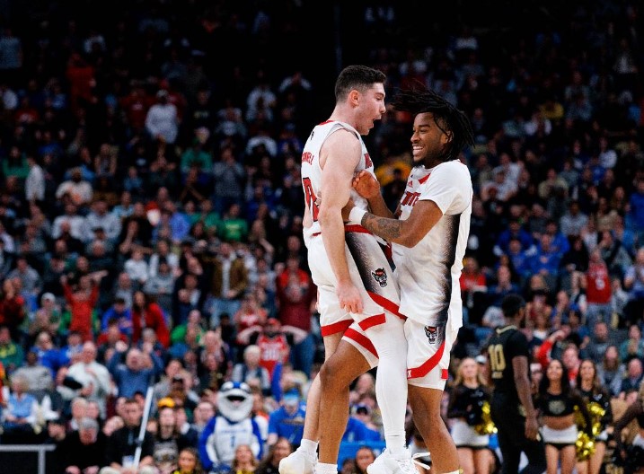 N.C. State’s Michael O’Connell and Jayden Taylor celebrate following the Wolfpack’s 79-73 overtime win against Oakland in the second round of the NCAA Tournament