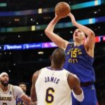 Nikola Jokic #15 of the Denver Nuggets shoots the ball against LeBron James #6 of the Los Angeles Lakers