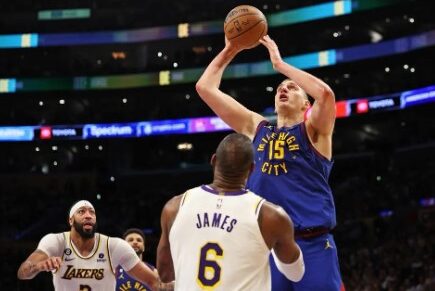 Nikola Jokic #15 of the Denver Nuggets shoots the ball against LeBron James #6 of the Los Angeles Lakers